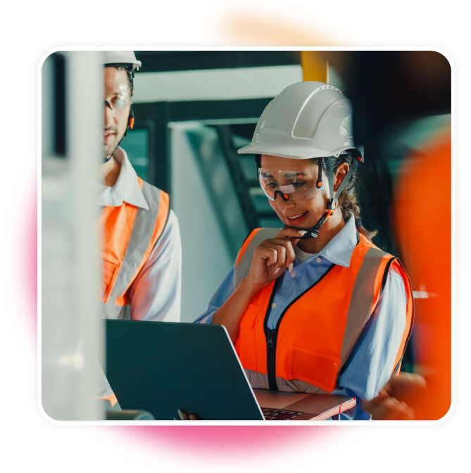 Woman looking at a laptop in construction uniform.