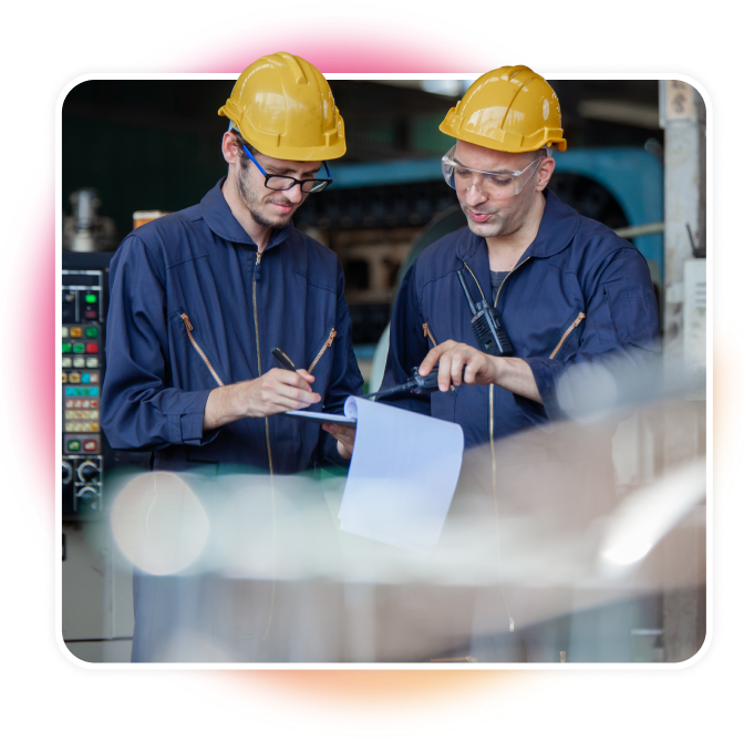 Two men looking at a clipboard in work uniforms.