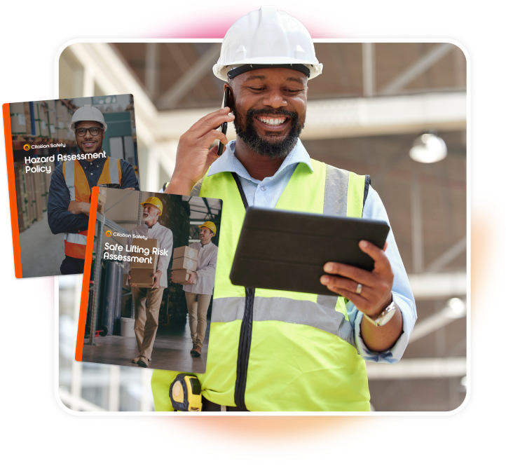 Male construction worker on the phone smiling at tablet. Mockups of health and safety policies.