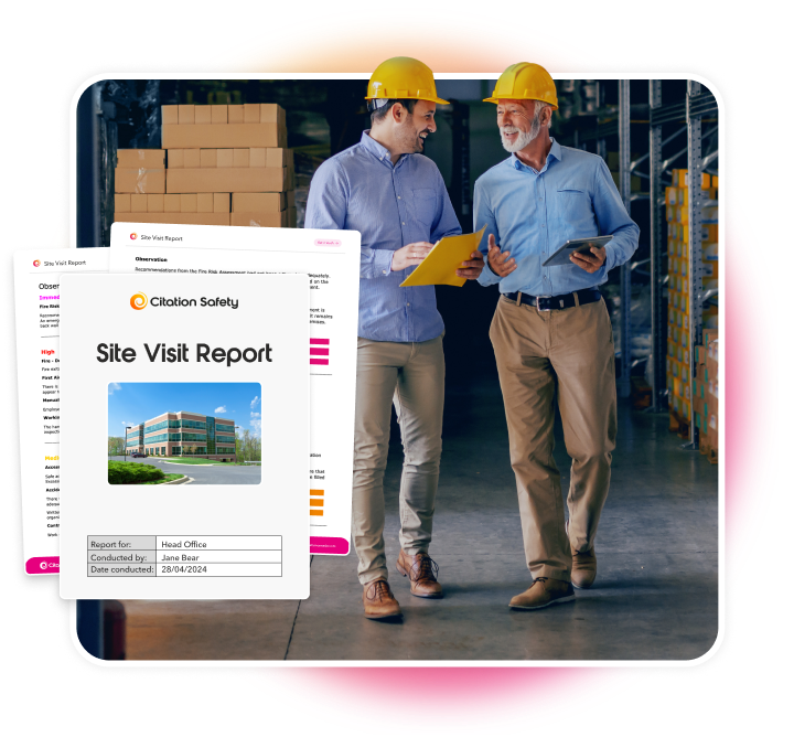 Two men wearing hard helmets walking through a warehouse discussing inspection.