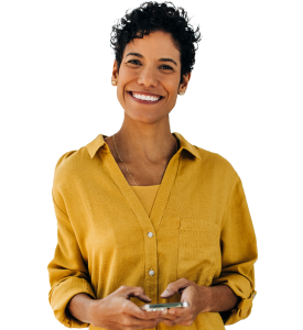 Woman smiling at camera, holding a phone.