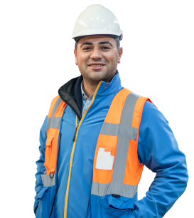 Man in construction uniform smiling at camera.