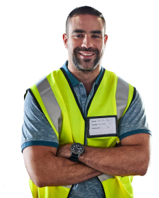 Man in construction uniform smiling at camera.