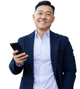 Man smiling at camera, holding a phone.