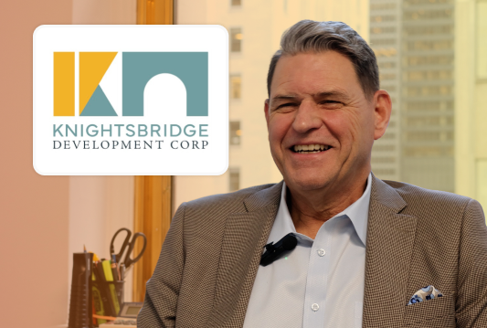 Knightsbridge Development Corporation's CEO is smiling in an interview.